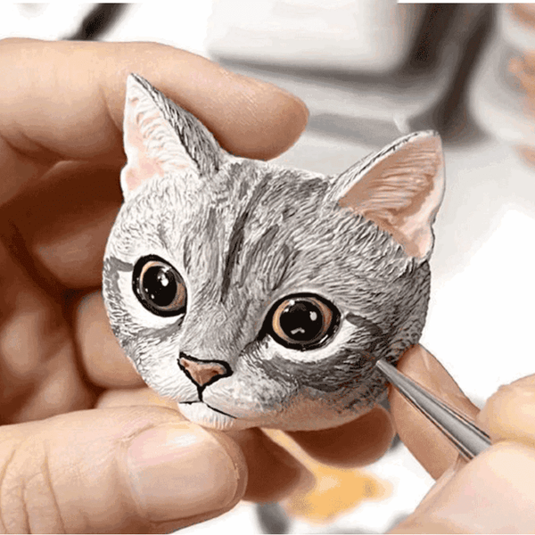 Artisan hand-sculpting custom 3D plaster pet portrait from photo reference